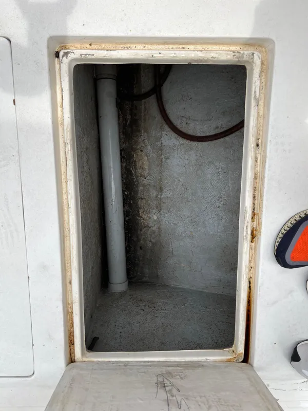 Open storage compartment on a 2000 Stuart Angler 32 Center Console boat.