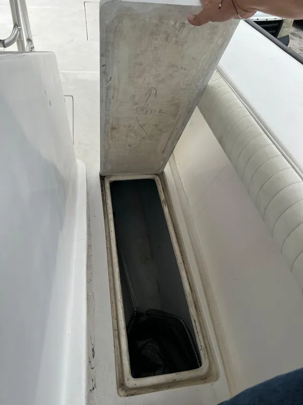Open storage compartment on 2000 Stuart Angler 32 Center Console boat.