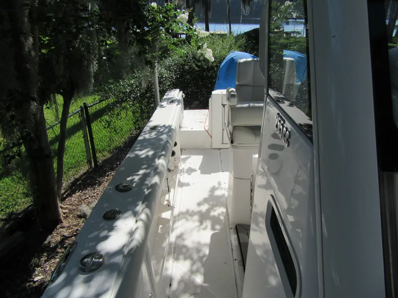 2017 Everglades 255 Center Console boat interior, side view with seating and rod holders.