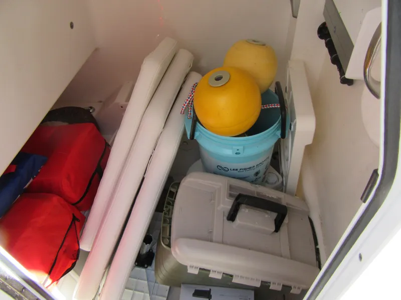 Storage compartment of a 2017 Everglades 255 Center Console boat with gear and equipment.
