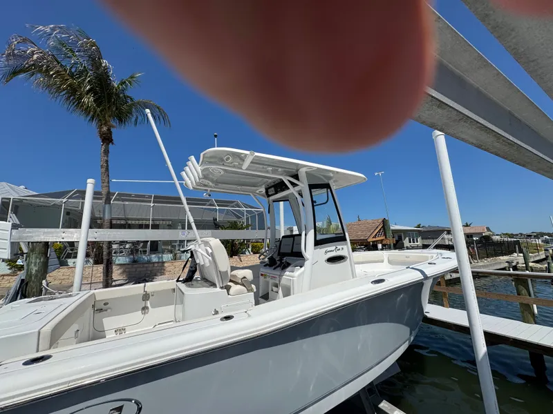 2024 Sea Hunt Gamefish 25 boat docked under sunny skies.