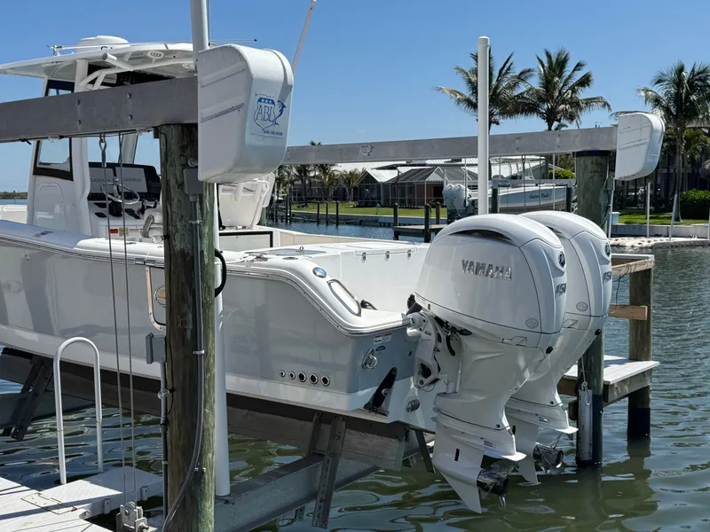 2024 Sea Hunt Gamefish 25 boat with Yamaha engines at dock.