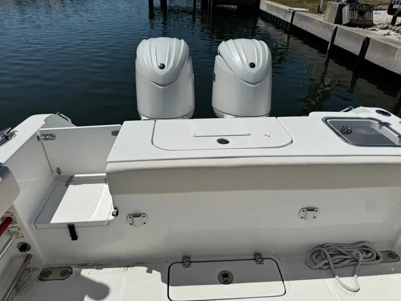 2024 Sea Hunt Gamefish 25 with twin outboard motors at dock.