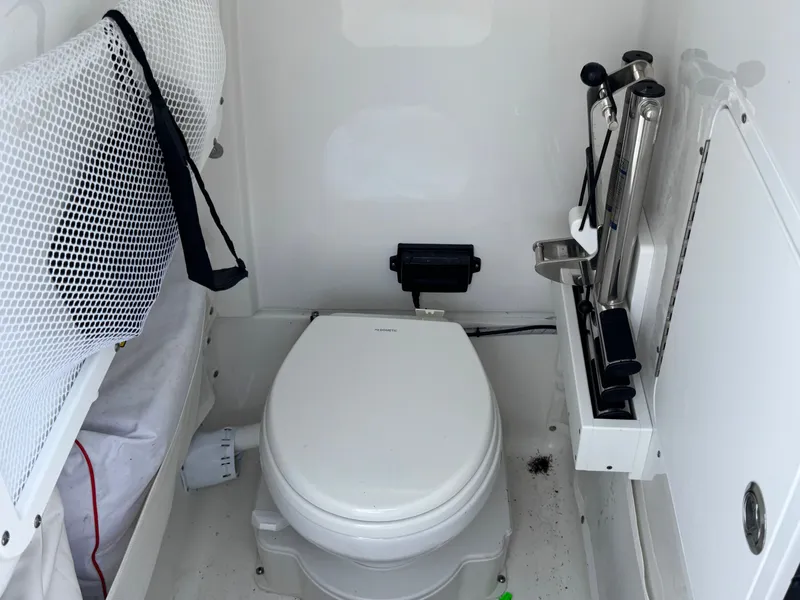 Interior of Sea Hunt Gamefish 25 with toilet, 2024 model.