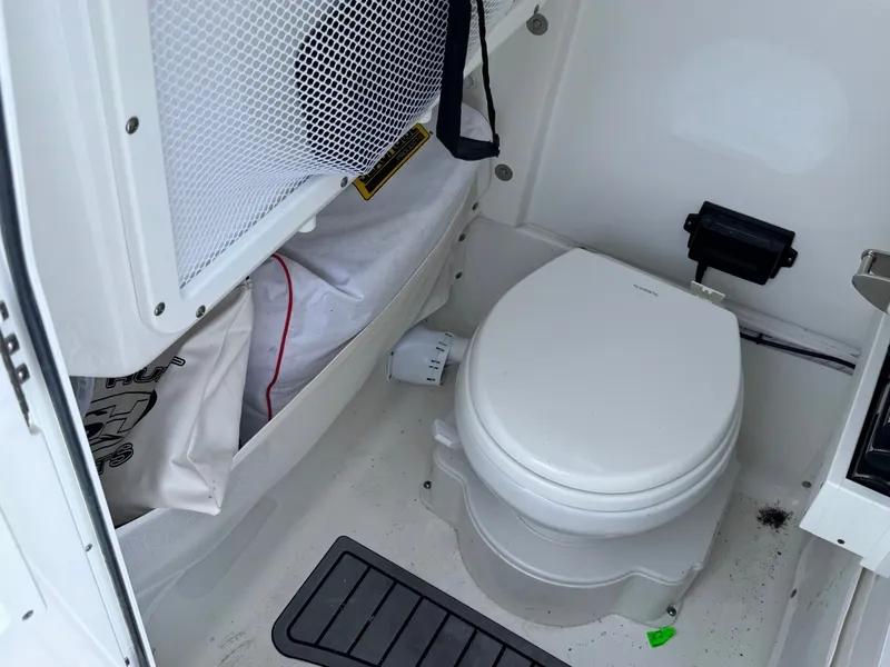 Interior of 2024 Sea Hunt Gamefish 25 with toilet.