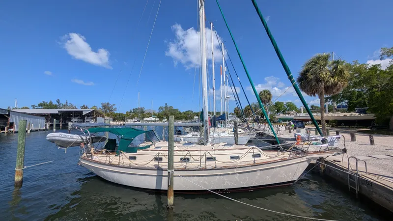 1998 Island Packet 40 sailboat docked in harbor on a sunny day.