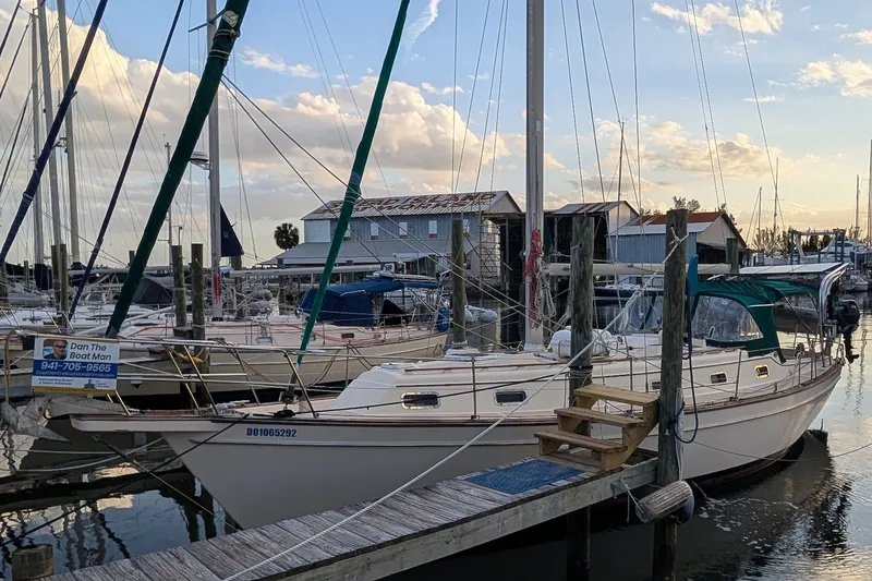 1998 Island Packet 40 sailboat docked at marina during sunset.