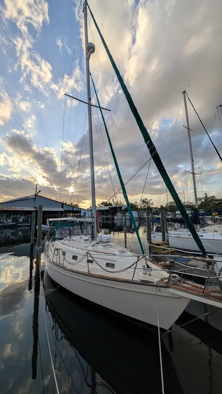 1998 Island Packet 40 sailboat docked at sunset.