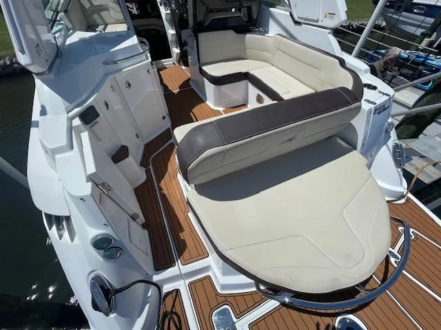 2019 Monterey 295 boat interior with beige seating and wood accents.