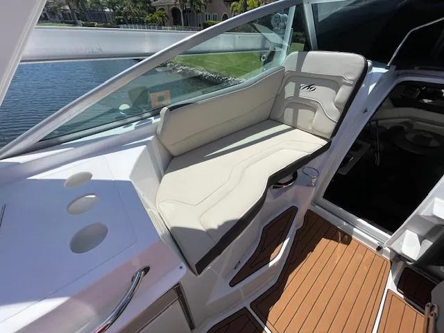 2019 Monterey 295 boat interior with beige seating and wooden flooring.