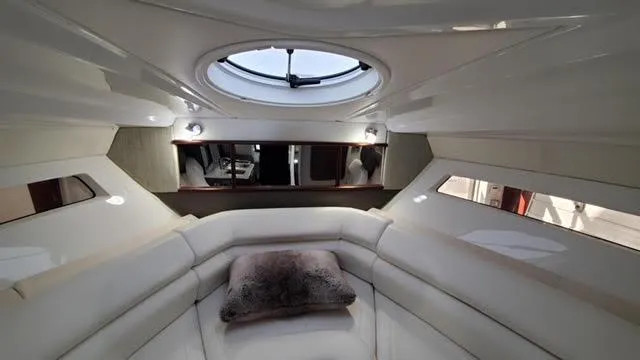Luxurious interior of a 2019 Monterey 295 yacht with plush seating and skylight.