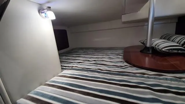 2019 Monterey 295 cabin interior with striped bedding and ambient lighting.