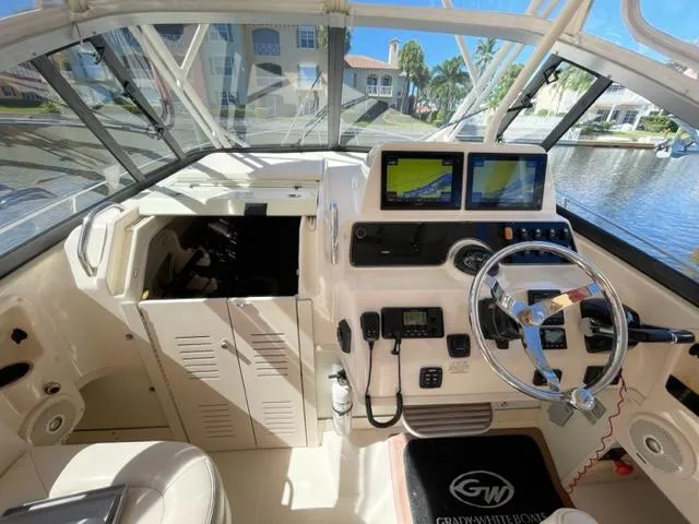 2017 Grady-White 300 Marlin boat cockpit with dual navigation screens and steering wheel.