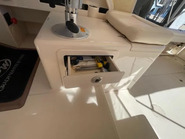 Grady-White 300 Marlin 2017 boat interior with open storage drawer and tools.