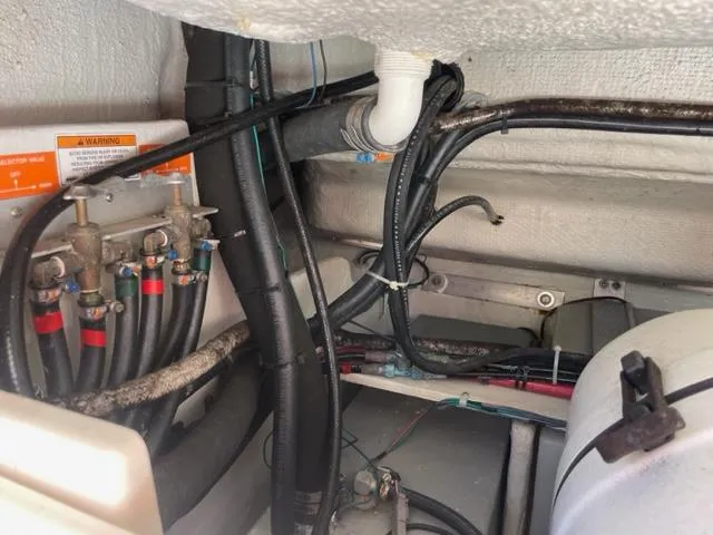 Engine compartment of a 2017 Grady-White 300 Marlin boat showing wiring and plumbing.