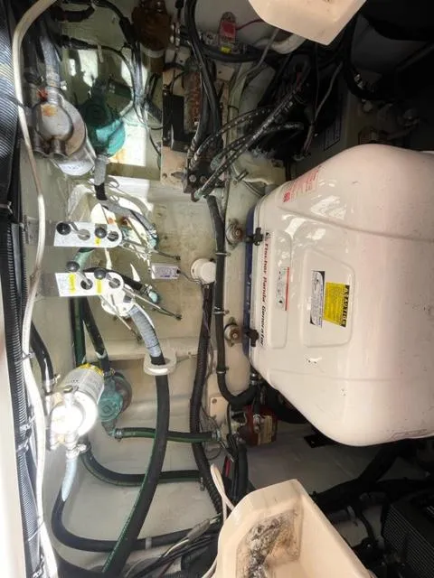 Engine compartment of a 2017 Grady-White 300 Marlin boat with various mechanical components.