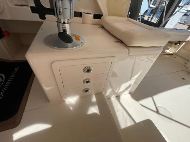 Interior of a 2017 Grady-White 300 Marlin boat with storage drawers and seating.