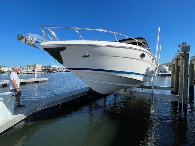 2014 Regal 3550 Cuddy on boat lift at dock.