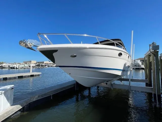 2014 Regal 3550 Cuddy boat docked under clear blue sky.