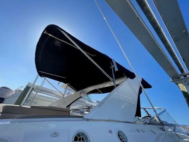 2014 Regal 3550 Cuddy with sunshade, blue sky.