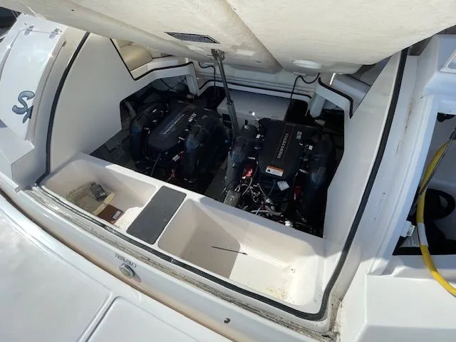 Engine compartment of a 2014 Regal 3550 Cuddy boat with dual engines.