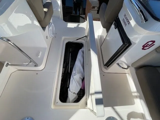 2014 Regal 3550 Cuddy with open storage compartment and fridge.