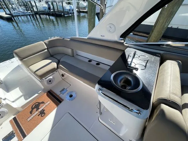 Interior of 2014 Regal 3550 Cuddy boat with seating and sink.