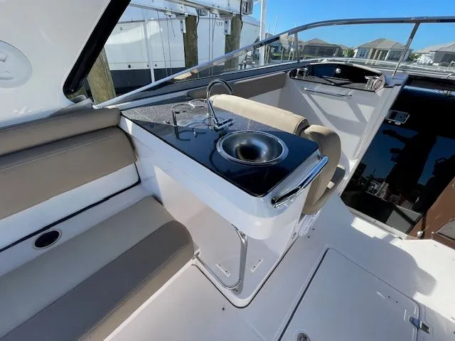 Interior of 2014 Regal 3550 Cuddy with sink and seating area.
