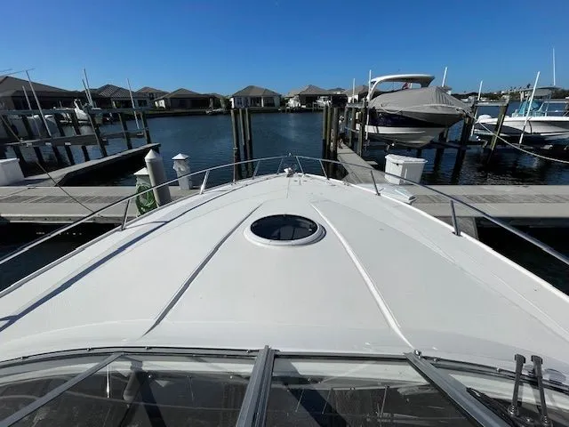 2014 Regal 3550 Cuddy at dock under clear sky.