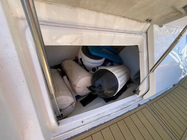 Storage compartment on a 2016 Sea Ray 510 DA with boating gear.