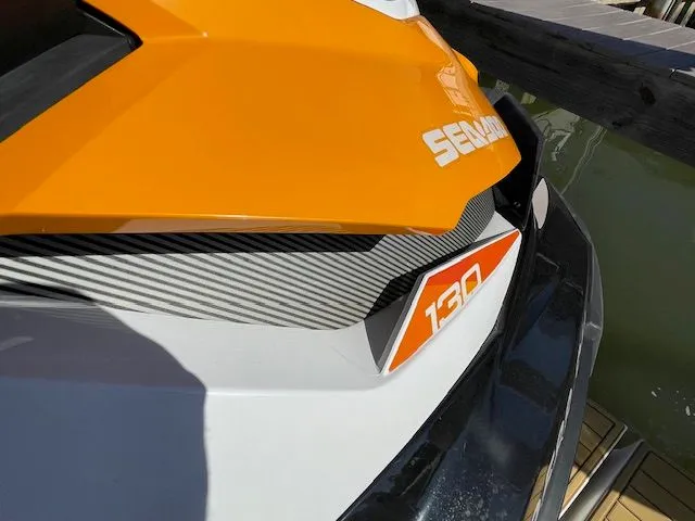 Close-up of an orange 2016 Sea Ray 510 DA at the dock.