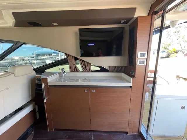 Interior of a 2016 Sea Ray 510 DA yacht with sink and TV.