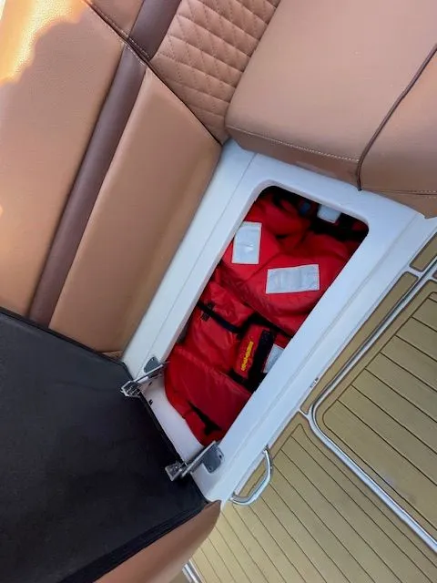 Red life jacket storage on 2016 Sea Ray 510 DA boat.