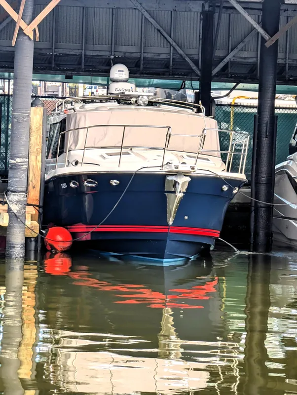 2022 Cutwater C-32 Coupe LE docked under a covered marina.