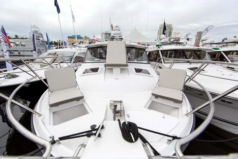 2022 Cutwater C-32 Coupe LE boat with spacious deck and seating at a marina.