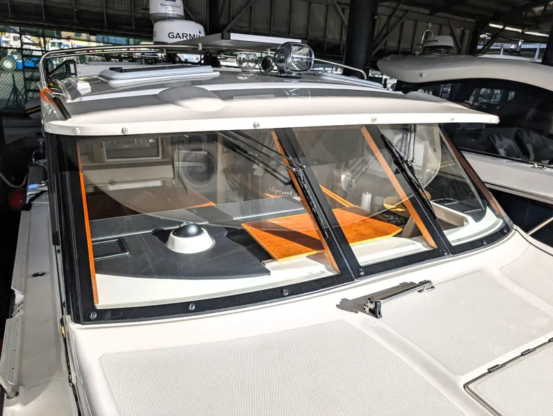 2022 Cutwater C-32 Coupe LE boat with Garmin equipment, docked in a marina.