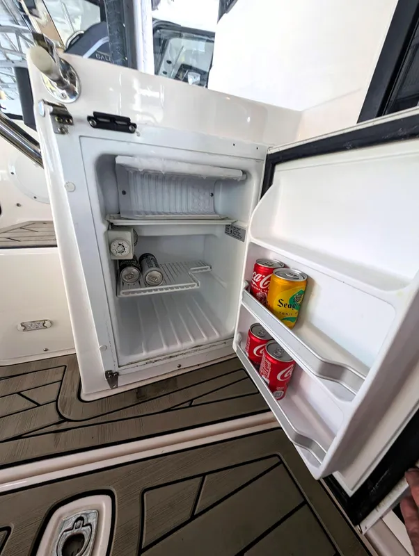 2022 Cutwater C-32 Coupe LE boat refrigerator with drinks inside.