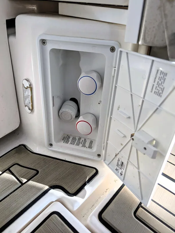 Cutwater C-32 Coupe LE 2022 boat water control panel with open access hatch.