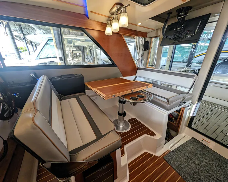 Interior of 2022 Cutwater C-32 Coupe LE with seating, table, and TV.