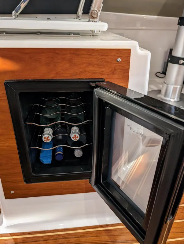 Mini fridge with beverages inside Cutwater C-32 Coupe LE 2022 boat.